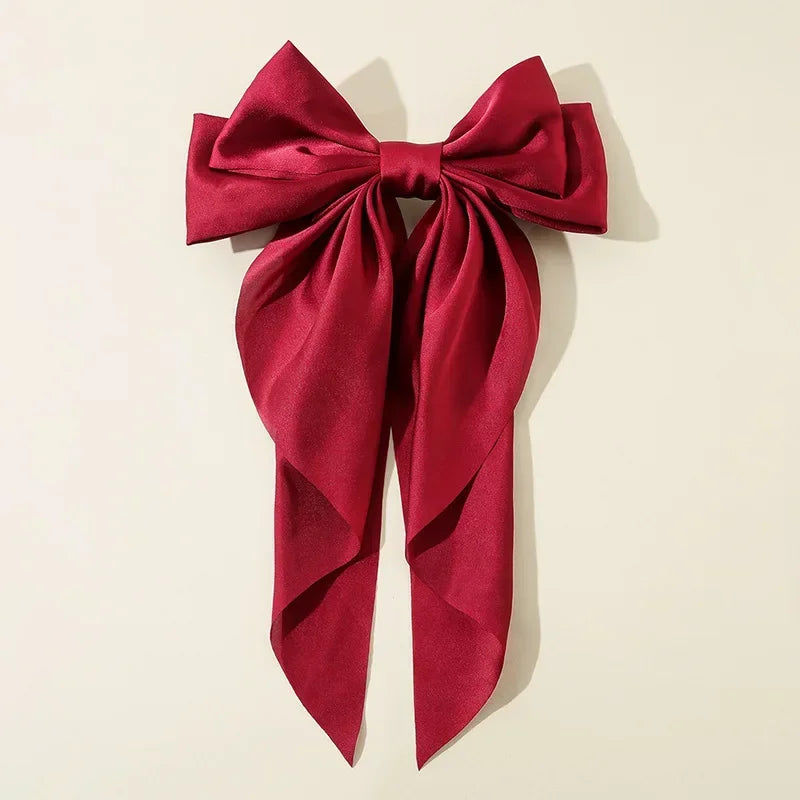 Ansoff Korean hair accessories featuring large satin bowknot clips with long ribbons, ideal for women and girls' spring hairstyles.