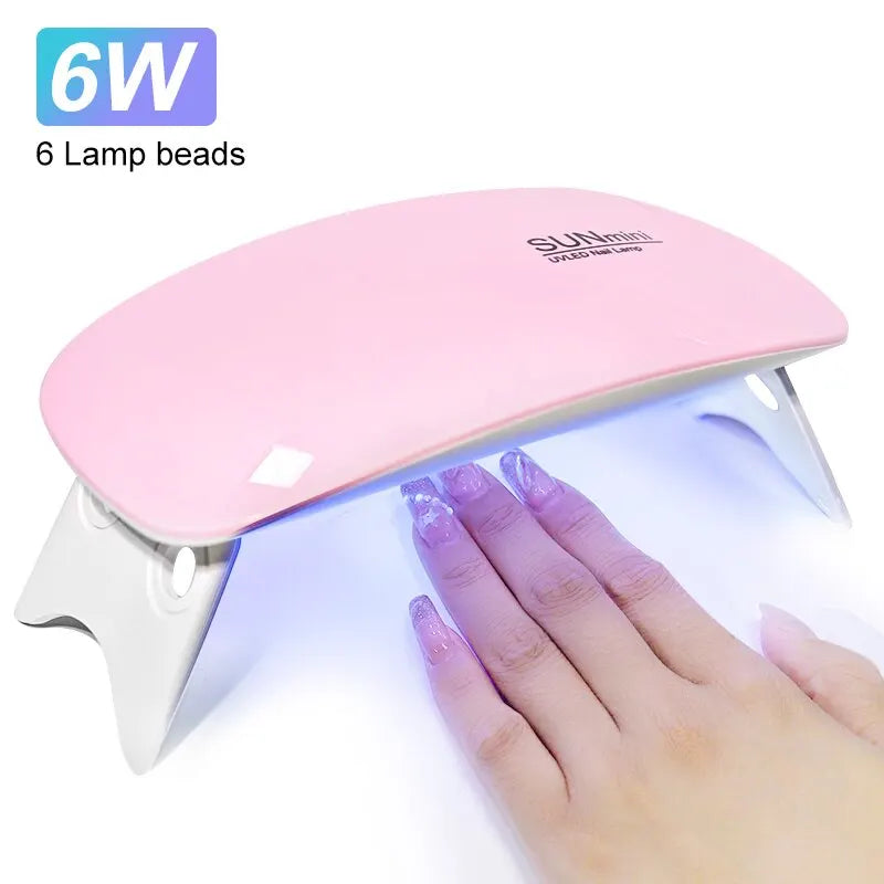 Ansoff 6W mini portable UV nail dryer with 6 LED lights, compact design, and USB cable for quick home manicure polish drying.