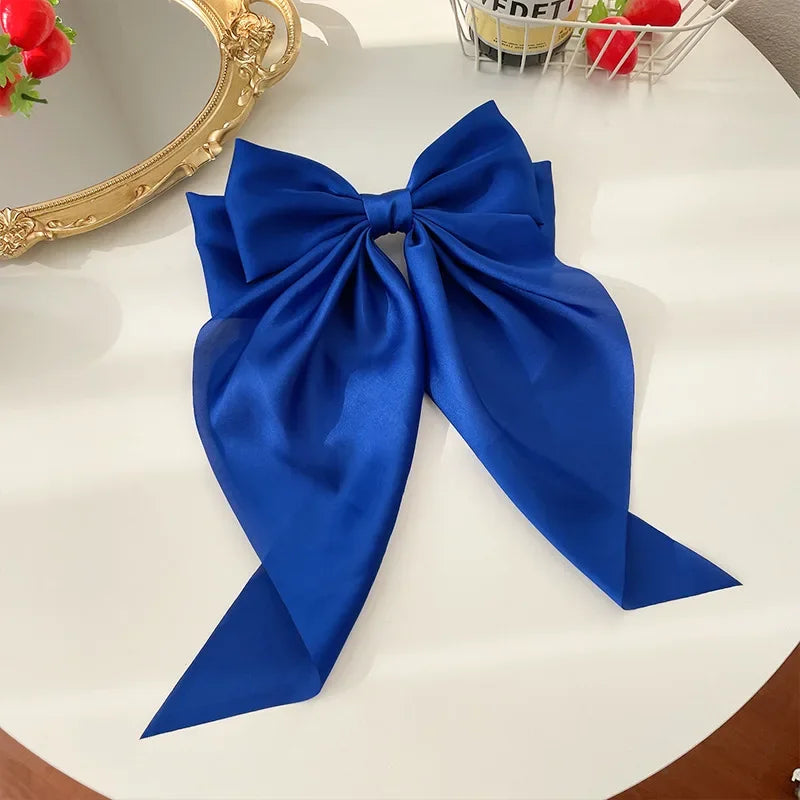Ansoff Korean women's hair clip featuring a large satin bowknot with long ribbon, spring clamp style for girls and women.