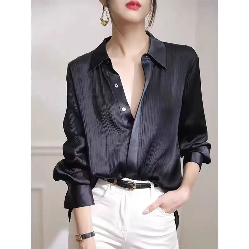 Black satin women's long-sleeved blouse with a loose fit, ideal for office wear and elegant spring fashion by Ansoff.