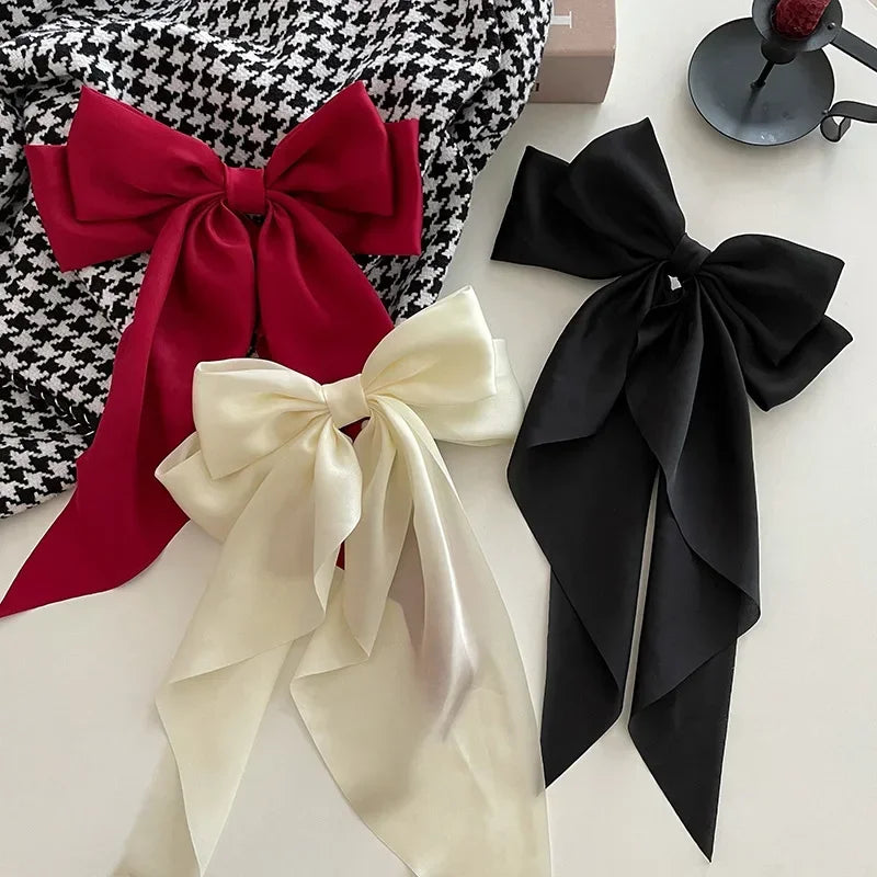 Ansoff Korean hair accessories featuring large satin bowknot clips with long ribbons and spring clamps for women and girls.